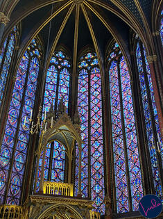 stained glass windows in Paris Sainte-Chapelle with king's throne in front